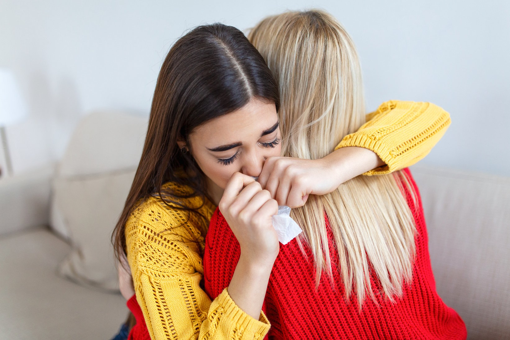 Condolence and support concept. Caring woman hugging her crying girlfriend, comforting her after receiving bad news